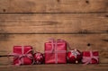 Christmas presents with a red white checked ribbon on old wooden Royalty Free Stock Photo