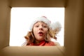 Surprised girl looking into christmas gift box Royalty Free Stock Photo