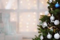 Christmas presents in white boxes on a window under a Christmas tree Royalty Free Stock Photo