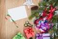 Christmas presents wrapping and snow fir tree over wooden table Royalty Free Stock Photo