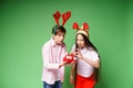 Christmas presents. Young guy and his girlfriend with red christmas deer horns Royalty Free Stock Photo