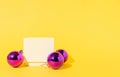 Christmas purple ornament balls on yellow background with white gift box. Showcase, podium, pedestal for products. New Year, Royalty Free Stock Photo