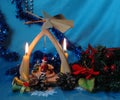 Christmas pyramid with candles, a wreath of fir branches and flo Royalty Free Stock Photo