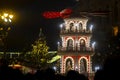 Christmas pyramid at festive street fair, night scene