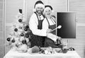 Christmas recipe concept. Menu for our family. Man and woman chef santa hat near christmas tree hold blackboard copy