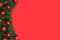 Christmas red background with fir branches and red baubles. Happy new year. Space for text. Copy space, template. Top view, flat Royalty Free Stock Photo