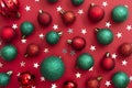 Christmas red background with red and green baubles, glitter with copy space. Winter christmas frame border. Royalty Free Stock Photo