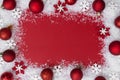 Christmas red background with snow, snowflakes frame and baubles. Winter, festive holiday mock up, copy space. Abstract Royalty Free Stock Photo