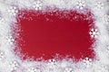 Christmas red background with snow and snowflakes frame. Winter, festive holiday mock up, copy space. Abstract red christams Royalty Free Stock Photo