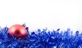 Christmas red ball in blue tinsel Royalty Free Stock Photo