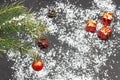 Christmas. Red ball and cone on spruce branch. Three gifts in red package