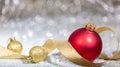 Christmas red ball, golden ribbon and snow, abstract bokeh lights background Royalty Free Stock Photo