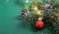 Christmas red ball, Christmas tree, ornaments and defocused lights background on green background. Concept: Christmas and New Year Royalty Free Stock Photo