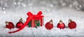 Christmas red balls and gift box on snow, abstract bokeh lights background Royalty Free Stock Photo