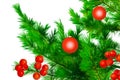 Christmas red balls and rowan berries on a background of green spruce branches close-up on a white isolated background Royalty Free Stock Photo