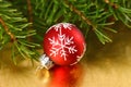 Christmas red bauble with snowflake ornament on gold background Royalty Free Stock Photo