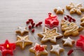 Christmas red berry fruit, home made cookies in shape of star and tree with icing on white wooden background, copy space for text Royalty Free Stock Photo