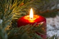 Christmas red candle wit fir closeup