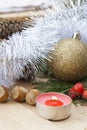 Christmas red candle on wooden table among Christmas and New Year ball and decor Royalty Free Stock Photo