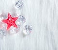 Christmas red crystal star on ice cubes and fur Royalty Free Stock Photo