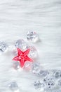 Christmas red crystal star on ice cubes and fur Royalty Free Stock Photo