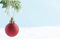 Christmas red decoration ball or bauble hanging on christmas fir branches, isolated. Winter greeting card with copy space Royalty Free Stock Photo