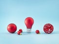 Christmas red decoration balls for New year tree on pastel blue background. One ball is a shining light bulb. Creative Winter Royalty Free Stock Photo