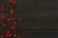 Christmas red lights border on grey wooden background Royalty Free Stock Photo