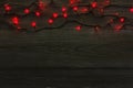 Christmas red lights border on grey wooden background Royalty Free Stock Photo