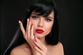 Christmas red lips makeup and Manicured nails. Beautiful brunette girl closeup portrait. Sensual young woman with xmas eye shadow Royalty Free Stock Photo