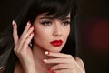 Christmas red lips makeup and Manicured nails. Beautiful brunette girl closeup portrait. Sensual young woman with xmas eye shadow Royalty Free Stock Photo