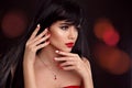 Christmas red lips makeup and Manicured nails. Beautiful brunette girl closeup portrait. Sensual young woman with xmas eye shadow Royalty Free Stock Photo