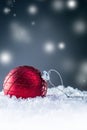 Christmas red Luxury ball in snow and abstract snowy atmosphere