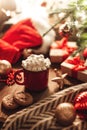 Christmas red mug with cocoa and marshmallows and cookies on a wooden table. New Year`s still life with a Christmas tree, a Santa Royalty Free Stock Photo