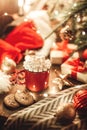 Christmas red mug with cocoa and marshmallows and cookies on a wooden table. New Year`s still life with a Christmas tree, a Santa Royalty Free Stock Photo