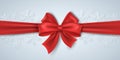 Christmas red ribbon with bowknot on the background of paper snowflakes. Luxury, silk tape. Happy new year concept. Graphic for