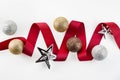 Christmas red ribbon decorate with silver glitter ornament balls and star on white background Royalty Free Stock Photo