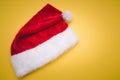 Christmas red Santa Claus hat with white pompom yellow . Decoration background Royalty Free Stock Photo