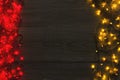 Christmas red and yellow lights border on grey wooden background Royalty Free Stock Photo