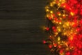 Christmas red and yellow lights border on grey wooden background Royalty Free Stock Photo