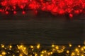 Christmas red and yellow lights border on grey wooden background Royalty Free Stock Photo