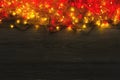 Christmas red and yellow lights border on grey wooden background Royalty Free Stock Photo