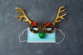 Christmas reindeer with medical face mask and party eyeglasses. Coronavirus protection minimal concept Royalty Free Stock Photo