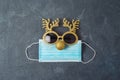 Christmas reindeer with medical face mask and party eyeglasses. Coronavirus protection minimal concept