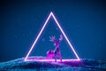 Christmas reindeer in a neon glowing purple portal on a classic blue background Royalty Free Stock Photo