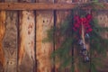 Christmas retro red handmade decoration with tree branches on the wooden background fence