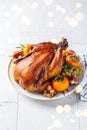 Christmas roasted whole chicken served with fruits on plate