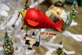 Christmas robot riding red blimp with Let it Snow sign on white fluffy Christmas tree