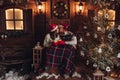 Christmas romance in Santa Claus hats beautiful house New Year`s atmosphere Royalty Free Stock Photo