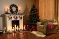 Christmas room interior design, Xmas tree decorated dy lights presents gifts toys, candles and garland lighting indoors fireplace. Royalty Free Stock Photo
